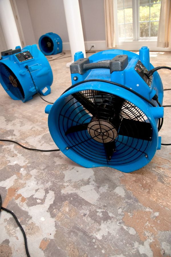 image of fans drying a water-damaged floor