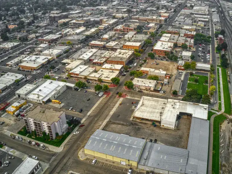 Aerial view of an urban area with low-rise buildings, parking lots, and streets. water damage restoration in Nampa